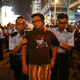 Police remove a pro-democracy protester during confrontations with anti-Occupiers in Mong Kok.
